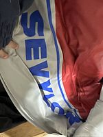 Close-up photo showing the Sevylor branding printed in blue on grey and red inflatable boat material.
