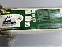 Photo of the box showing the Outbound brand, 3 Person Hexagonal Dome Tent name, and product details explaining the silver aluminized surface and overall design.