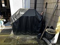 Full view of grill covered by black Weber logo cover