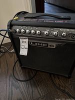 Front view of the Line 6 amplifier showing control knobs, input jacks, and branding.