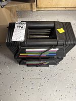 Top view of dumbbell stack with attached MaxSold auction label and yellow sticker.