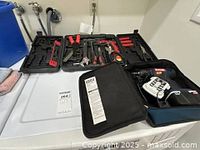 Opened Apollo folding tool case showing various hand tools and small accessories inside.