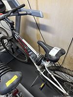 Side view of Trek 820 mountain bike showing frame, saddle, and part of the front tire with cable lock wrapped around seat post.