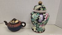 Photo showing both the clay teapot and floral ginger jar side by side