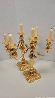 Both candelabras displayed together with candles attached