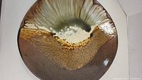 Top and angled view of large pottery plate showing color gradient and glaze