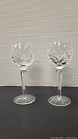 Two Waterford crystal wine glasses side by side showing cut diamond pattern and starburst base
