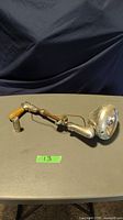 Photo of vintage alley light showing metal arm, plastic handle and light housing