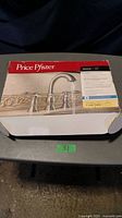 Box of Price Pfister lavatory faucet showing the packaging and product image.