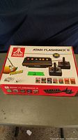 Box of Atari Flashback 8 showing console image, built-in games count (105), and Pitfall branding.
