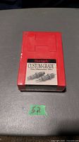 Red plastic box labeled Hornady Custom Grade New Dimension Dies with image of dies on front.