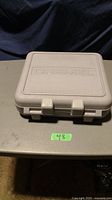 Closed gray plastic carrying case with Dremel logo on top