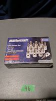 Front view of unopened Mastercraft 14-piece 3/8 inch drive bit socket set box showing brand and product details.