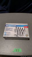 Closed unopened Mastercraft 14-piece 3/8" drive bit socket set in original box on table.