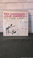 Cover of My Fair Lady vinyl record showing illustrated dancing couple with Rex Harrison and Julie Andrews credited