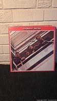 Front cover of The Beatles 1962-1966 vinyl album showing the band's iconic photo with the Fab Four looking over the balcony, red border