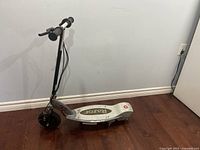 Full view of Razor electric scooter showing deck, front wheel, and handlebars.