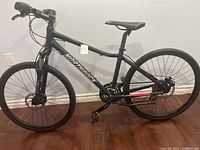 Full side profile of the black Northrock bike against wall