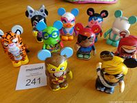 Group of 10 Disney Vinylmation figures on table, front view