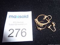 overview of four gold scrap pieces with lot tag