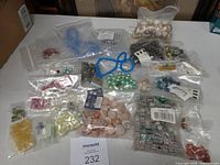 Overview of multiple bags of assorted beads and shells