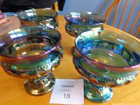 Four iridescent carnival glass compote dishes on table