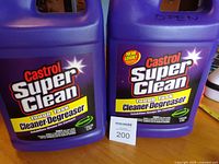 Front view of both Castrol Super Clean jugs displaying labels and fill status note