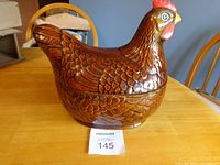 Left side full view of brown ceramic hen cookie jar