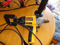Full view of DeWalt DW130V drill with cord, side and rear handles
