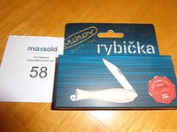 Front of boxed Mikov Rybicka fish-shaped pocket knife