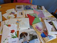 Spread of assorted greeting cards and envelopes on table