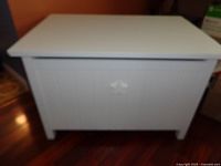 Full view of closed white toy chest showing star cut-out and overall appearance