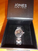 Watch seated in open Jones New York presentation box
