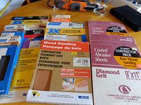 Front view showing all sandpaper packages on table