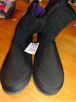 Front view of both boots with item tag