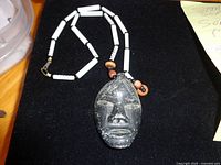 Full view of necklace with soapstone face pendant and bead strand