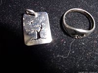 Charm and ring shown together on black background