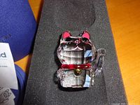 Lucky cat figurine seated in foam insert with box edge visible