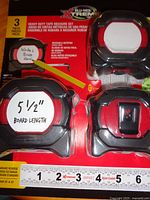 Front view of sealed package showing three tape measures and 25 ft scale