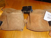 Front view showing both main pouches, buckle and overall wear