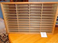 Front view showing shelves and dividers of wooden cassette rack