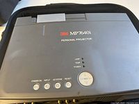 Top view of 3M MP7640i personal projector showing buttons and indicator lights