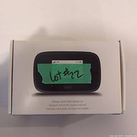 Closed box of MiFi mobile hotspot device with device image on front and a green tape label 'lot #22'.