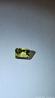 Front view of natural lemon citrine gemstone showing emerald cut and clarity.