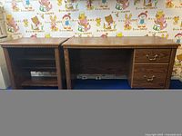 Front view of wood office desk next to the matching side table with shelving.