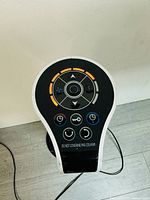 Top control panel showing various buttons for speed, temperature, timer, oscillation, and lock with LED indicators lit