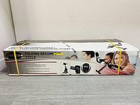 Photo of the folding recumbent exercise cycle box showing brand 'freesport' and features including foldable design, padded backrest, hand pulse sensors, and monitor functions.