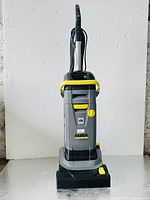 Front view of scrubber showing body, handle, and scrub head