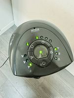 Top control panel of the Seville Classics tower fan showing buttons and indicator lights lit up, proving operational status.