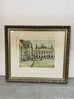Front view of framed antique wall art featuring a historic European street scene with classical architecture.